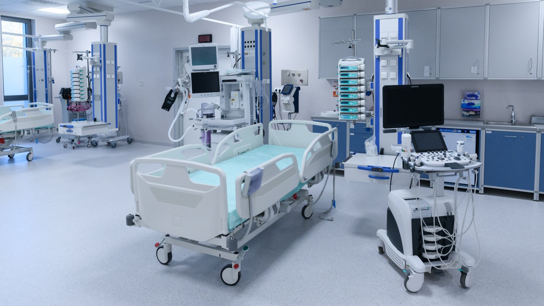 Na zdjęciu wnętrze sali z łóżkiem szpitalnym i sprzętem medycznym